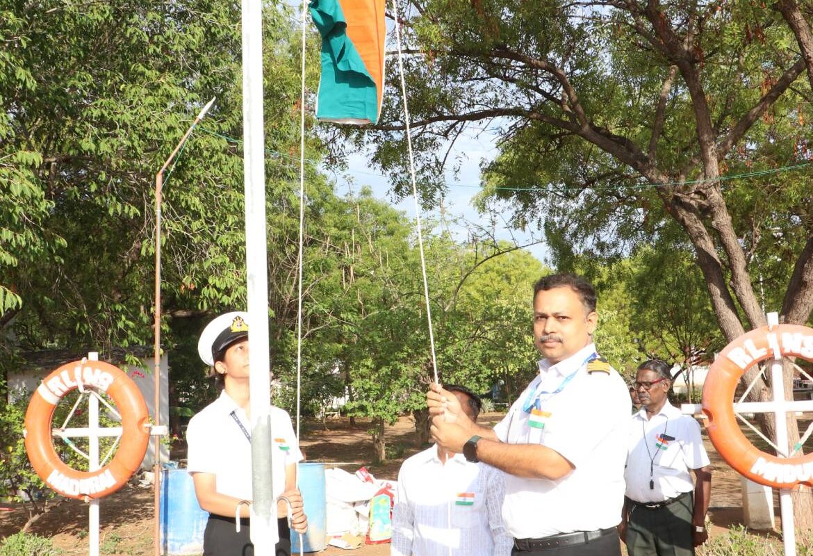 Principal hoisting the National Flag
