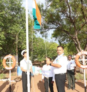 Principal hoisting the National Flag
