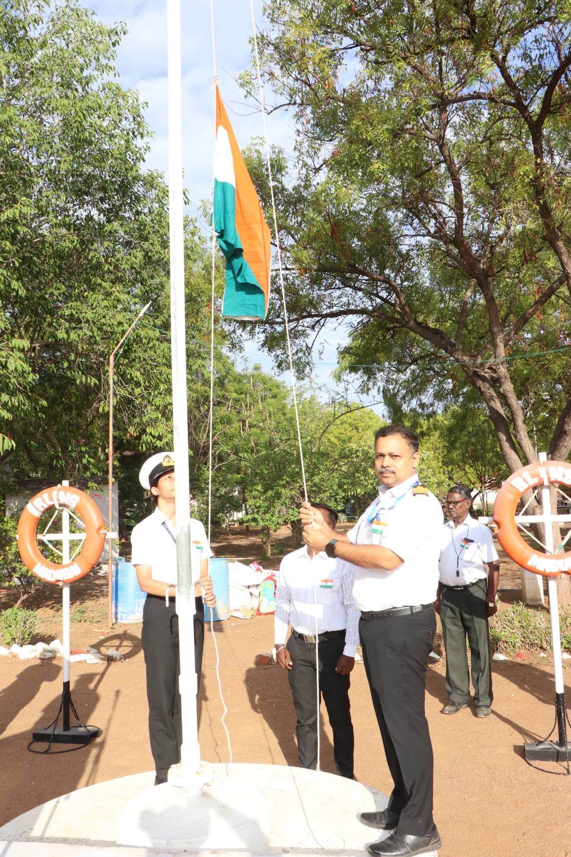 Principal hoisting the National Flag
